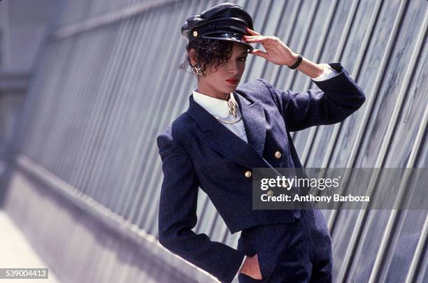 Portrait of an unidentified model in a leather, peaked cap and a double-breasted, bolero jacket, New York, 1980s.