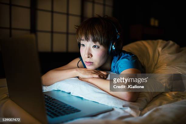 young woman relaxing at home - mood stream stock pictures, royalty-free photos & images