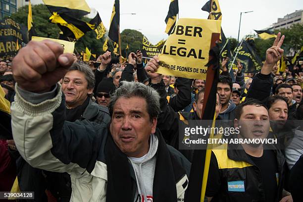 Taxi drivers demonstrate as they block 9 de Julio avenue during a protest against US multinational online transportation network company Uber, in...