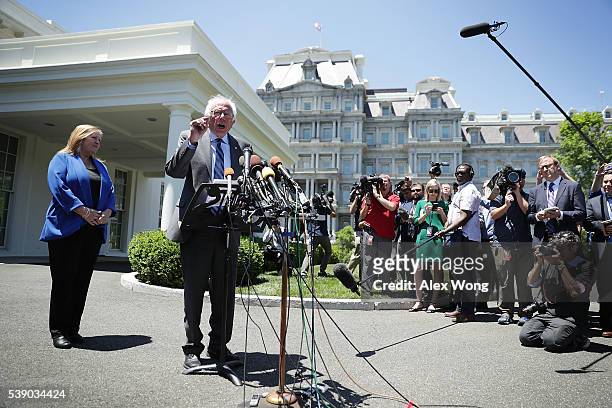Democratic presidential candidate Sen. Bernie Sanders speaks to members of the media as his wife Jane O'Meara Sanders looks on after an Oval Office...