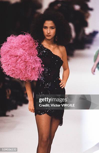 Model walks the runway at the Yves Saint Laurent Ready to Wear Spring/Summer 1991 fashion show during the Paris Fashion Week in October, 1990 in...