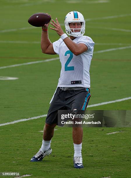 Zac Dysert of the Miami Dolphins throws the ball during the team's OTAs on June 9, 2016 at the Miami Dolphins training facility in Davie, Florida.