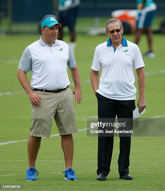 Executive Vice President of Football Operations Mike Tannenbaum talks to Chairman of the Board/Managing General Partner Stephen M. Ross of the Miami...