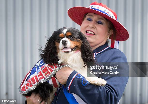 Angela Walker holds up her dog Berie who she has dressed to celebrate the Queen's 90th birthday this weekend on the first day of the Royal Cornwall...