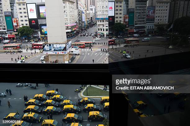 Taxi drivers demonstrate as they block 9 de Julio Avenue during a protest against US multinational online transportation network company Uber, in...
