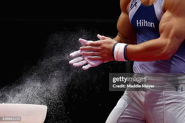 Sam Mikulak chalks his hands before competing in the Pommel Horse event during the Men's P&G Gymnastics Championships at the XL Center on June 3,...