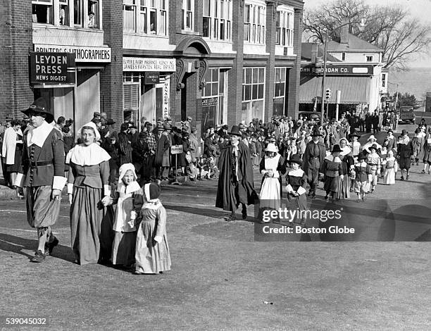 Pilgrims progress along Leyden Street to Burial Hill and grave of first Governor Robert F. Bradford in Plymouth, Mass., December 1947. Groups...