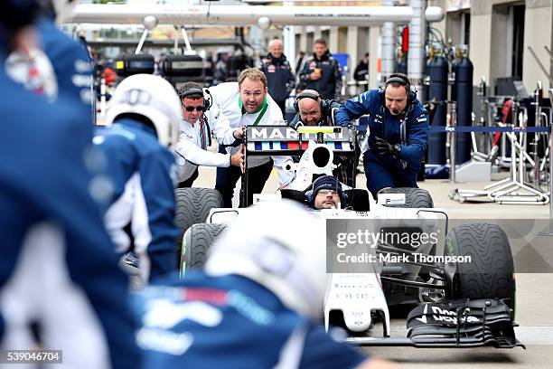 Heineken ambassador Scott Quinnell helps the Williams team during a pit stop practice during previews to the Canadian Formula One Grand Prix at...