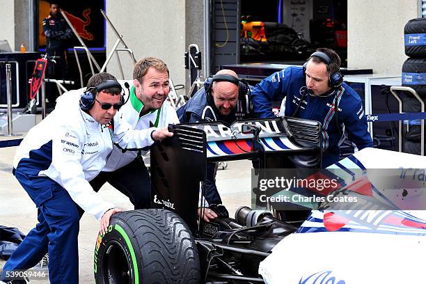 Heineken ambassador Scott Quinnell helps the Williams team during a pit stop practice during previews to the Canadian Formula One Grand Prix at...