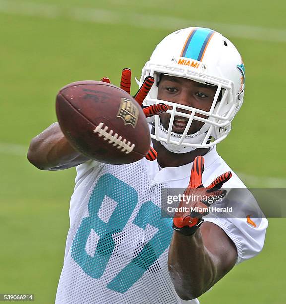 Miami Dolphins wide receiver Rashaw Scott catches a pass during week 3 of OTAs at the team's training facility in Davie, Fla., on Thursday, June 9,...