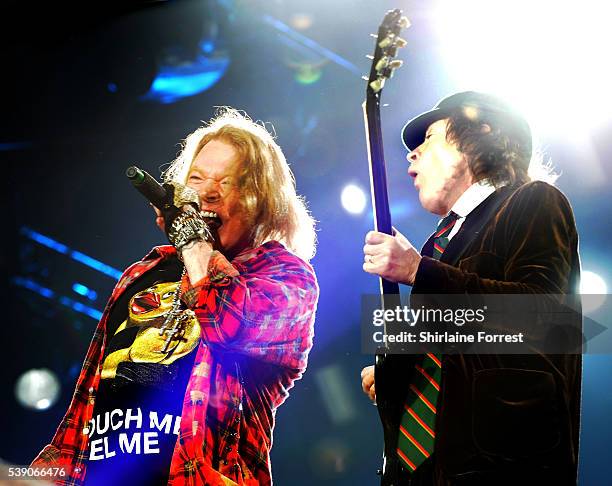 Axl Rose and Angus Young of AC/DC perform at Etihad Stadium on June 9, 2016 in Manchester, England.