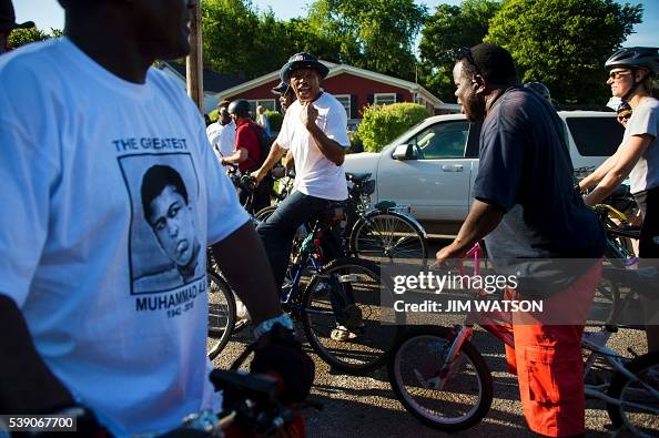 M Ali Rider Bike riders stop outside boxing legend Muhammad Ali's childhood home ...