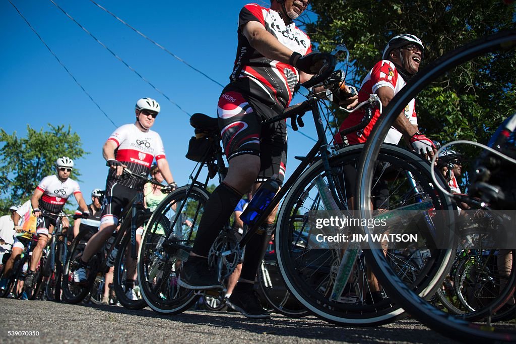 M Ali Rider Bike riders stop outside boxing legend Muhammad Ali's childhood home ...