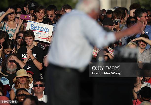 Supporters listen to Democratic presidential candidate Sen. Bernie Sanders' stump speech during a rally near the Robert F. Kennedy Memorial Stadium...