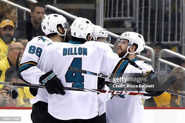 Brent Burns of the San Jose Sharks celebrates with his teammates after scoring a goal against Matt Murray of the Pittsburgh Penguins during the first...