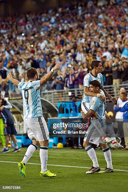 Ever Banega of Argentina celebrates a goal against Chile with his teammates Angel Di Maria and Gonzalo Higuain in the second half during a group D...