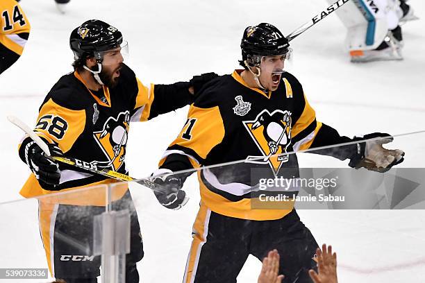 Evgeni Malkin of the Pittsburgh Penguins celebrates with Kris Letang after scoring a goal against Martin Jones of the San Jose Sharks during the...