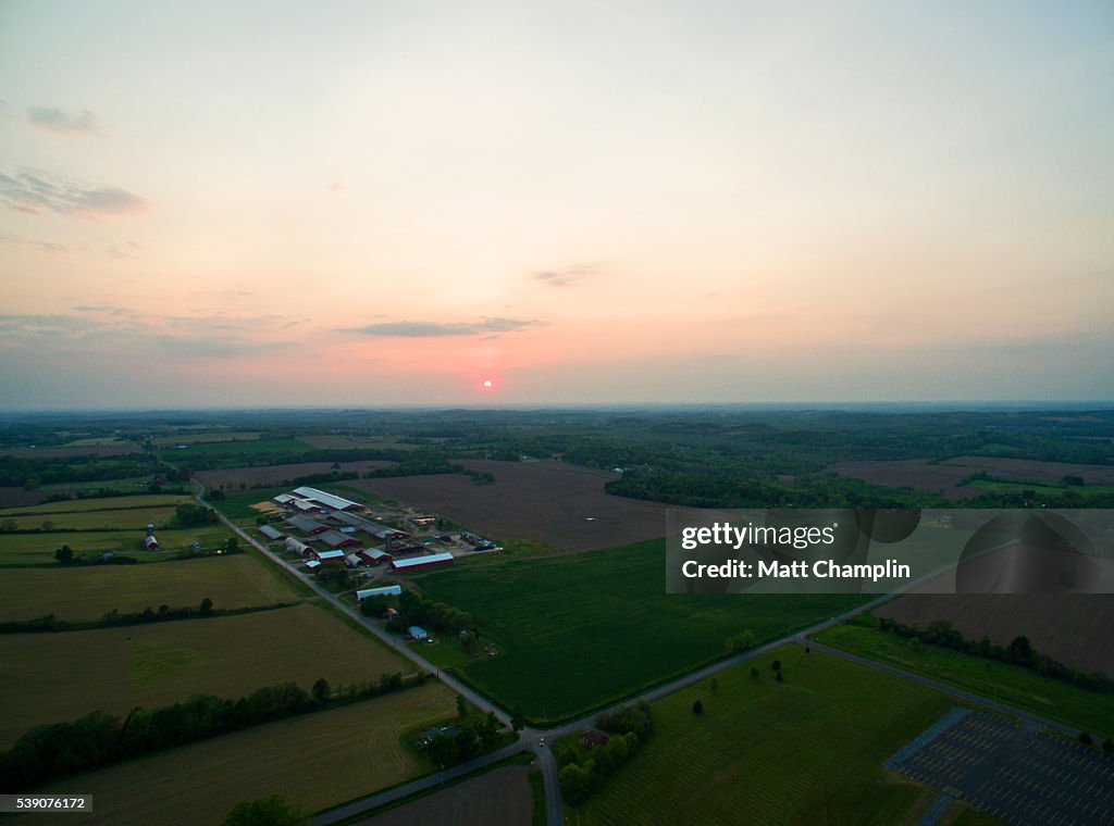 Aerial of sunset over dairy farm