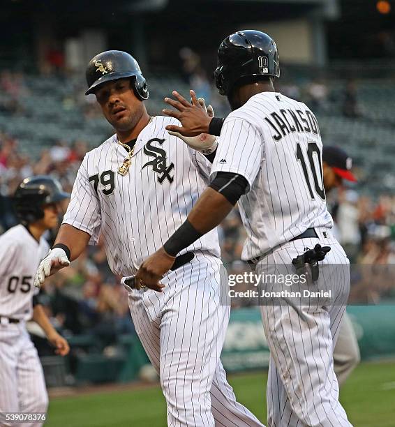 Jose Abreu and Austin Jackson of the Chicago White Sox celebrate after scoring runs in the 1st inning against the Washington Nationals at U.S....
