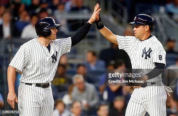 Jacoby Ellsbury and Chris Parmelee of the New York Yankees celebrate after both scored in the fifth inning against the Los Angeles Angels of Anaheim...