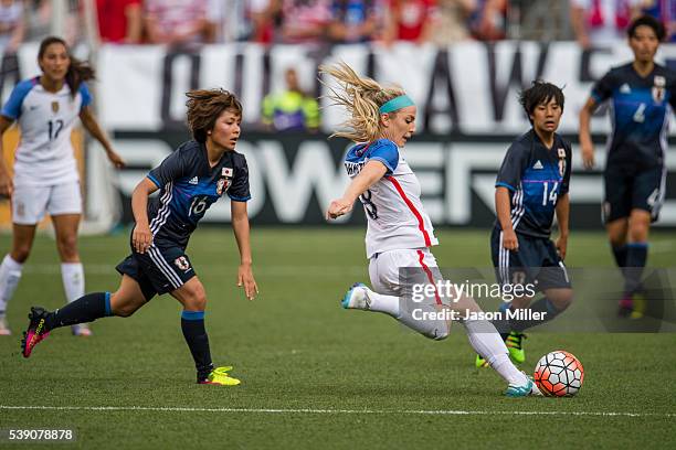 Mana Iwabuchi of Japan puts pressure on Julie Johnston of the U.S. Women's National Team during the second half of a friendly match on June 5, 2016...