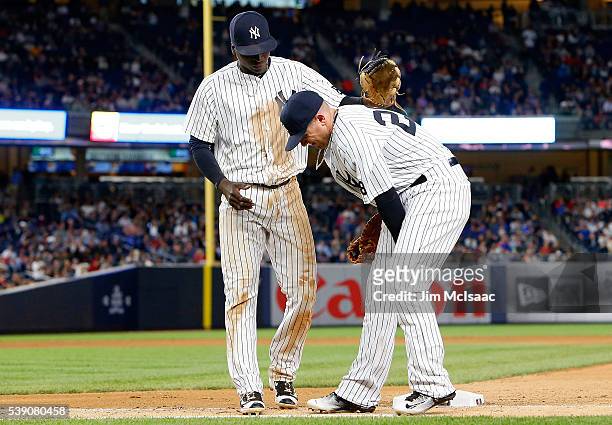 Chris Parmelee of the New York Yankees grimaces after an injury on the final out of the seventh inning against the Los Angeles Angels of Anaheim as...