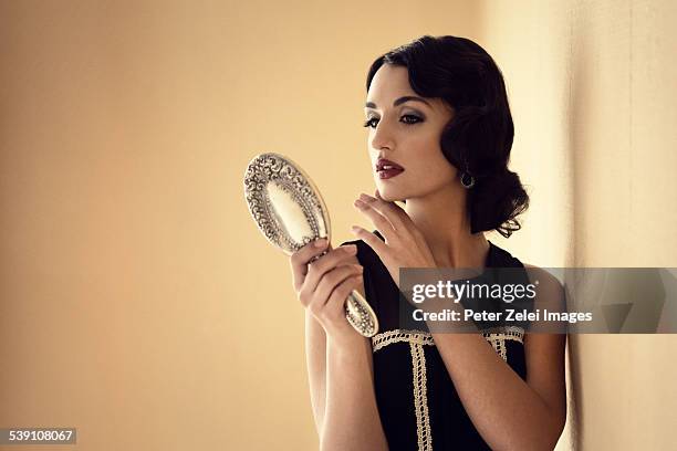 retro woman with mirror - zwanziger jahre stock-fotos und bilder