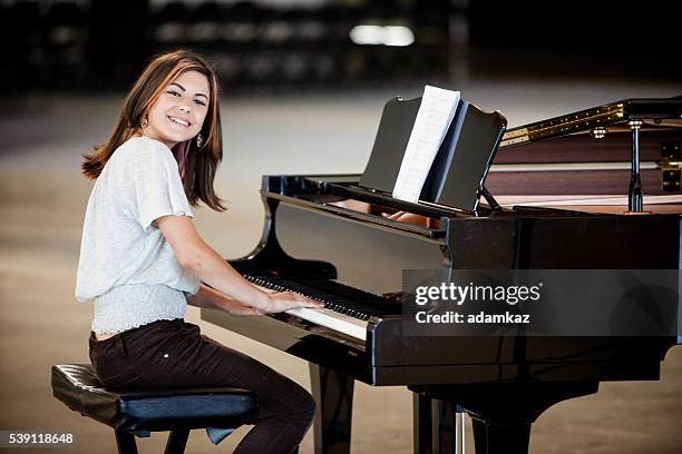 cute young girl playing piano - concert pianist stock pictures, royalty-free photos & images