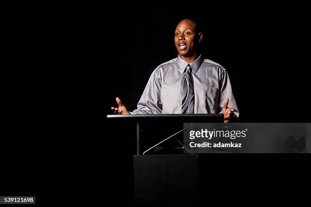african american man making a speech at a podium - lectern stock pictures, royalty-free photos & images