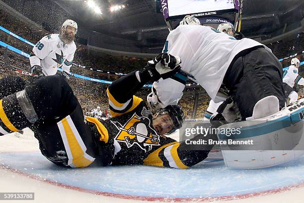 Evgeni Malkin of the Pittsburgh Penguins collides into Martin Jones of the San Jose Sharks during the second period in Game Five of the 2016 NHL...