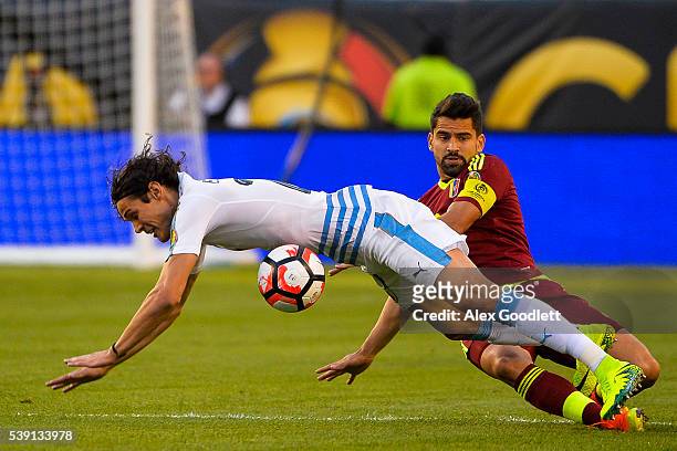Edinson Cavani of Uruguay fights for the ball with Tomas Rincon of Venezuela during a group C match between Uruguay and Venezuela at Lincoln...