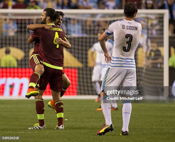 Tomas Rincon and Oswaldo Vizcarrondo of Venezuela embrace in front of Diego Godin of Uruguay during the 2016 Copa America Centenario Group C match at...