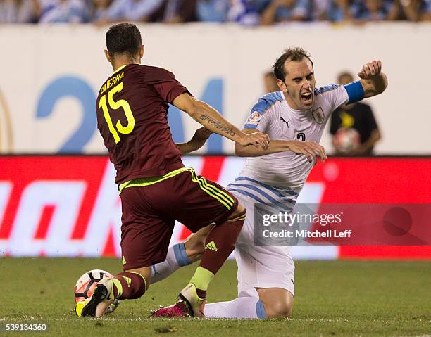 Alejandro Guerra of Venezuela steals the ball from Diego Godin of Uruguay during the 2016 Copa America Centenario Group C match at Lincoln Financial...