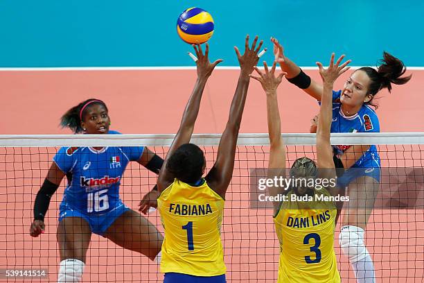 Anastasia Guerra#14 of Italy spikes the ball as Fabiana Claudino and Dani Lins of Brazil defend during the match between Brazil and Italy on day 1...