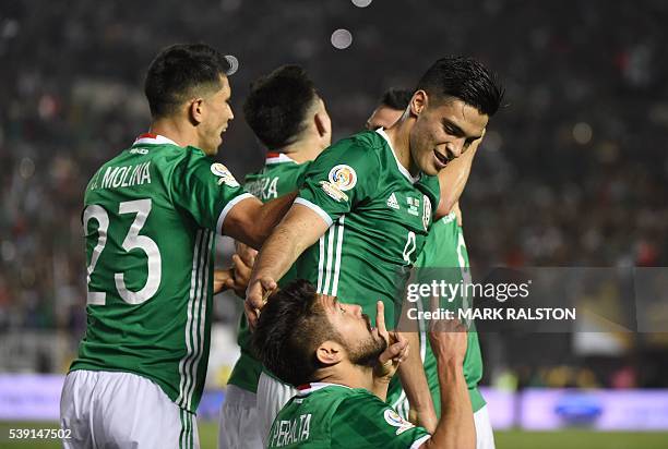 Mexico's Oribe Peralta prays next to teammate Raul Jimenez after scoring against Jamaica during their Copa America Centenario football tournament...