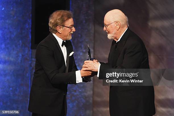 Honoree John Williams accepts the AFI Life Achievement Award from director Steven Spielberg onstage during American Film Institutes 44th Life...