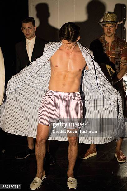 Model prepares backstage before the fashion show at the 7th Annual amfAR Inspiration Gala at Skylight at Moynihan Station on June 9, 2016 in New York...