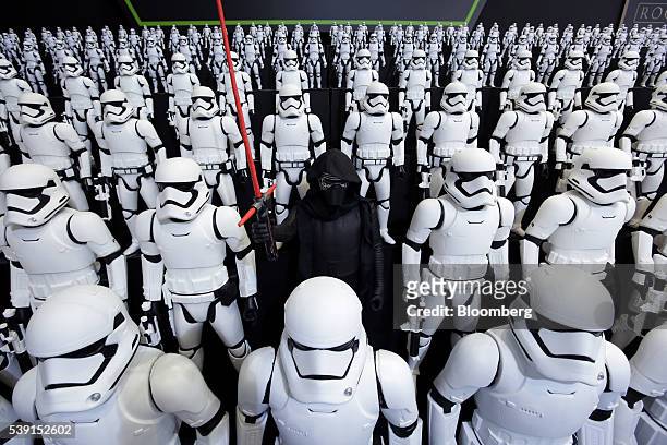Figurines of Kylo Ren, center, and First Order Stormtroopers, characters from "Star Wars", are displayed at the Tomy Co. Booth at the International...