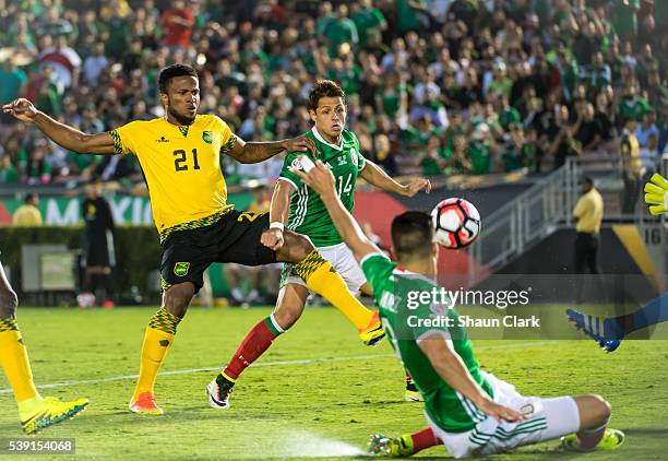 Raul Jimenez of Mexico crosses the ball for Javier Hernandez of Mexico as Jermaine Taylor of Jamaica defends during the Copa America Centenario Group...