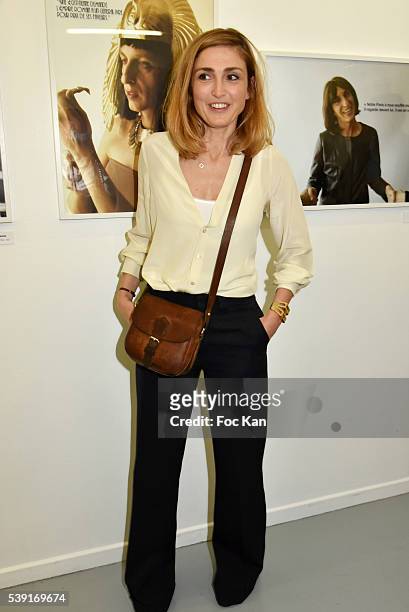 Julie Gayet poses with portraits of Stephanie Foenkinos travestite in politician women shot by Stephane Murat "55 Politiques" : Exhibition Preview at...