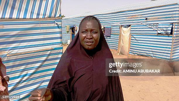 Displaced person Aisha Bala speaks outside her tent about lack of adequate food in the Dalori Internally Displaced People's Camp for people displaced...