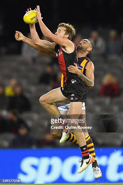 Martin Gleeson of the Bombers marks infront of Shaun Burgoyne of the Hawks during the round 12 AFL match between the Essendon Bombers and the...