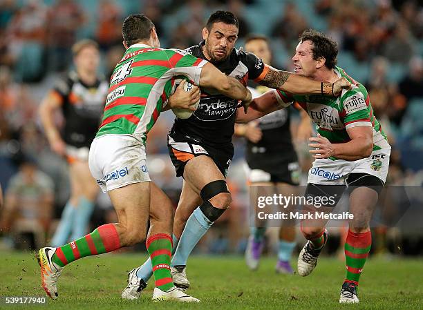 Dene Halatau of the Tigers is tackled during the round 14 NRL match between the Wests Tigers and the South Sydney Rabbitohs at ANZ Stadium on June...