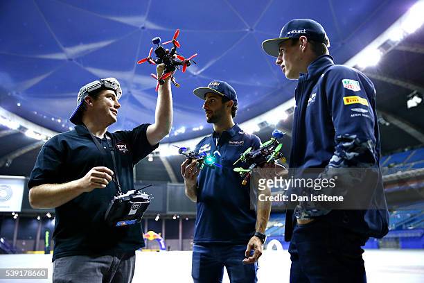 Daniel Ricciardo of Australia and Red Bull Racing and Max Verstappen of Netherlands and Red Bull Racing talk about racing drones during previews to...