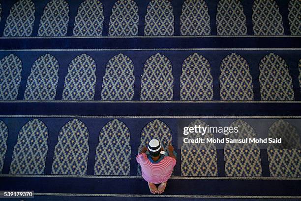 An Indian Muslim man is seen performing a prayer inside the India Muslim mosque during the holy month of Ramadan on June 10, 2016 in Klang, Malaysia....