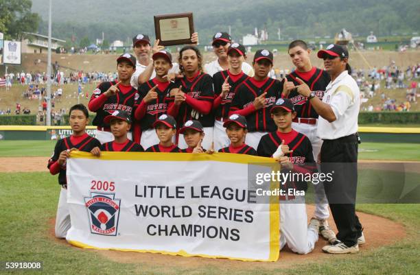 The Northwest team poses with the championship banner after their win over the Caribbean team during the Championship Game of the Little League World...