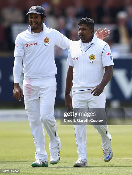 Rangana Herath of Sri Lanka celebrates with Dimuth Karunaratne after dismissing Steven Finn of England during day two of the 3rd Investec Test match...