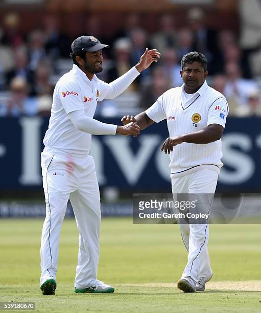 Rangana Herath of Sri Lanka celebrates with Dimuth Karunaratne after dismissing Steven Finn of England during day two of the 3rd Investec Test match...