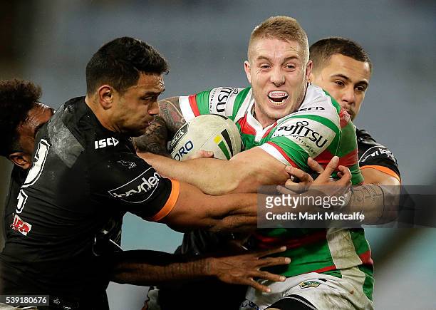 Aaron Gray of the Rabbitohs is tackled during the round 14 NRL match between the Wests Tigers and the South Sydney Rabbitohs at ANZ Stadium on June...