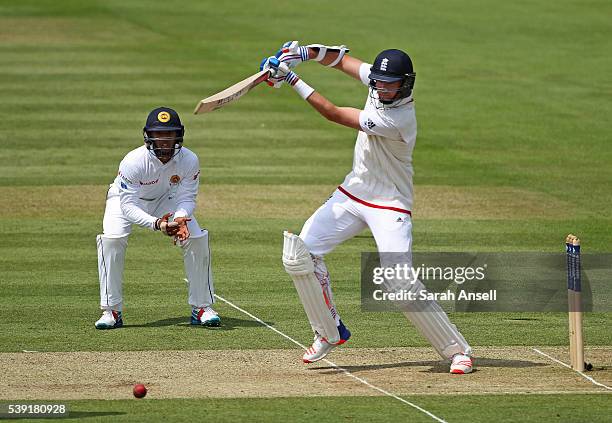 England's Stuart Broad hits out as Kusal Mendis of Sri Lanka looks on during day two of the 3rd Investec Test match between England and Sri Lanka at...